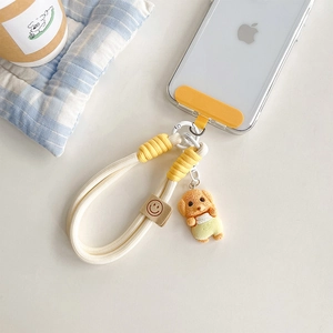 Vue détaillée du cordon de téléphone tressé jaune et blanc avec pendentif de chien
