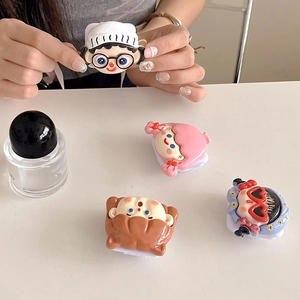 Detailed view of four cute 3D cartoon girl phone grips on a clean white desk setup