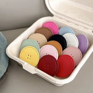 Collapsible round leather texture phone socket grips in multiple vibrant colors