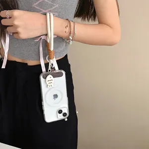 Detail of hand-woven phone lanyard with white fish charm and magnetic case on model