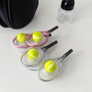 Close-up of mini tennis racket phone stands in pink and silver with fuzzy yellow balls