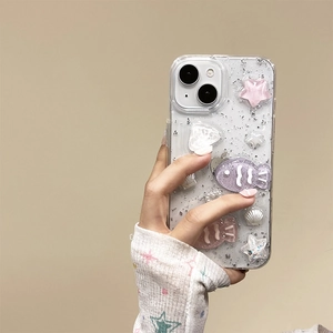 Detail of iPhone glitter case with handmade resin fish, shells, and sparkling star charms