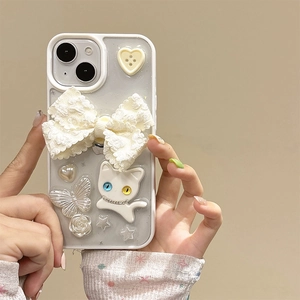 Detail of white lace bow and 3D white cat relief on glittery iPhone phone case
