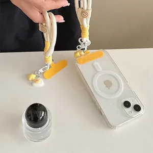 Magnetic clear phone case with yellow braided lanyard and cute cartoon pendants