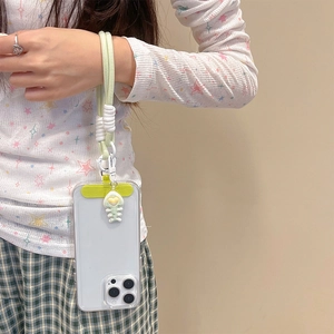 Chic light green braided phone wrist strap with heart charm on a floral outfit model
