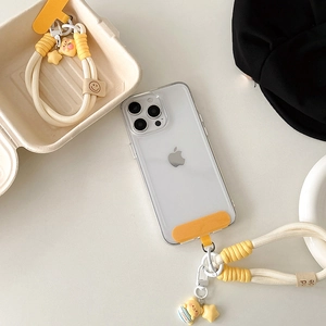 Detail of braided phone wrist strap with bear charm and yellow star ornament