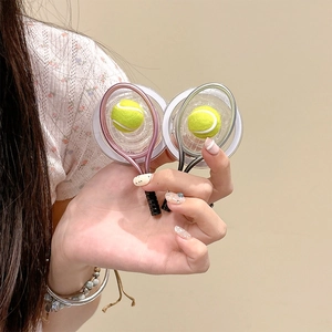 Detail of creative pink and silver mini tennis racket phone grips with 3D fuzzy balls