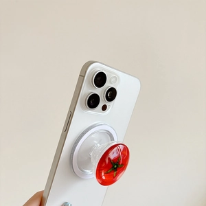 Creative 3D red tomato collapsible phone socket grip on a white smartphone back