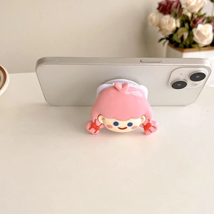 Close-up of pink cartoon girl phone grip with mirror on white smartphone