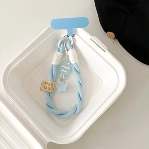 Detail of light blue braided phone strap with handmade label and blue fish charm