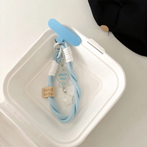Close-up of light blue braided phone strap with fish charm and Hand Made leather label