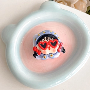 Detail of cute 3D cartoon girl phone grip with red heart sunglasses and floral headscarf