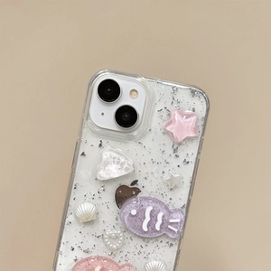 Detail of iPhone glitter case with 3D resin stars, fish, shells and pearl heart elements