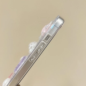 Detail shot of iPhone glitter case side buttons with 3D resin heart and bow decorations
