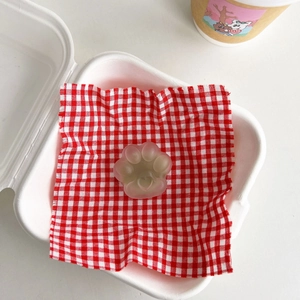 Detail of a translucent gradient cat paw phone grip featuring a heart detail on fabric