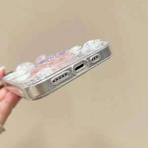 Detail shot of iPhone glitter case showing precise bottom cutouts and resin charms