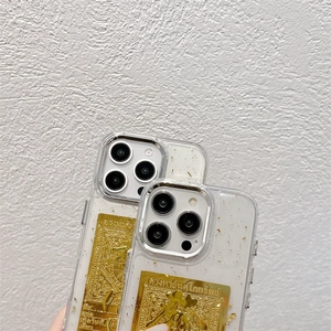 Detail of transparent iPhone case with embedded gold foil and Thai wealth talisman design
