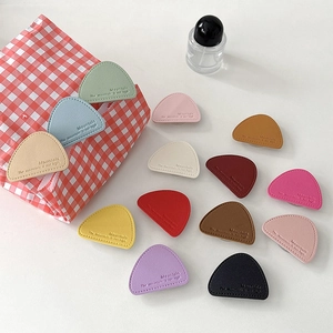 Faux leather triangular phone socket grip set in multiple colors with mountain embossing