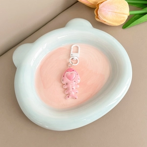 Close-up of pink fishbone keychain with lovely heart detail and white spring hook