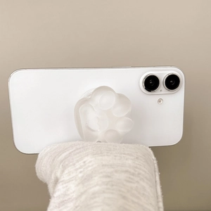 Detail of translucent frosted cat paw phone socket holder on a white smartphone