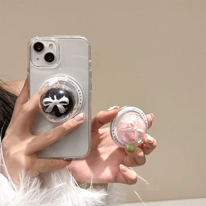 Detail of spherical phone socket featuring a soft white bow and plush texture