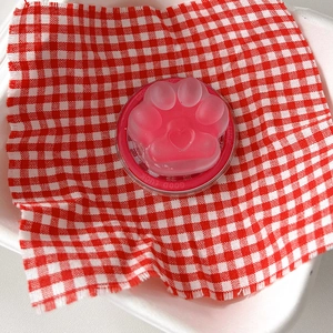 Detail of pink cat paw phone grip with matte texture and heart-shaped relief detail