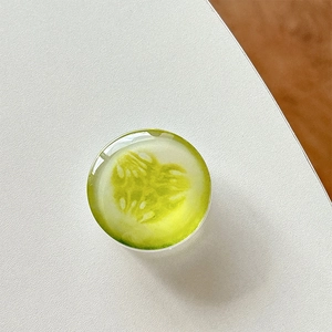 Macro detail of a cucumber slice phone grip with clear crystal resin finish