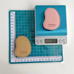 Solid color mango leather phone grip stand with handcrafted stitching and embossed text