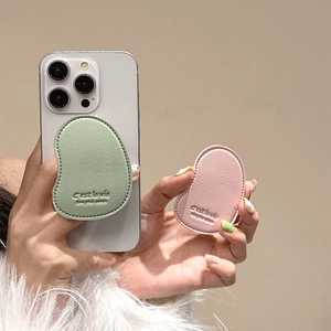 Detail of mango-shaped leather phone socket with lychee texture and fine stitching