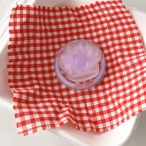 Detail of lavender cat paw phone socket with heart accent on red checkered cloth