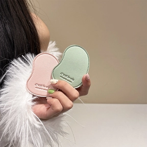 Close-up of leather phone grips in pink and green with elegant debossed text details