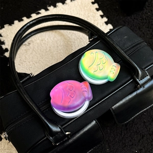 Detail of colorful gradient laser fish griptok with scale texture on leather bag