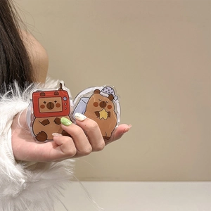 Detail of cute Capybara acrylic phone grips featuring TV mask and purple nightcap designs