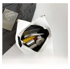 Macro shot of white tote bag interior showing large capacity and polygonal structure