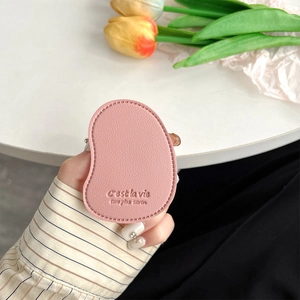 Close-up of pink leather mango-shaped phone grip with C'est la vie embossed text
