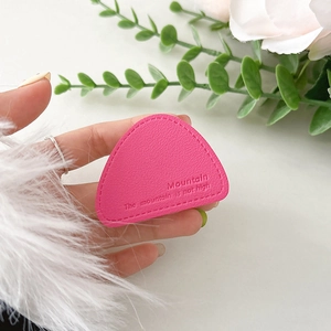 Macro detail of rose red leather phone grip with precision stitching and embossed quote