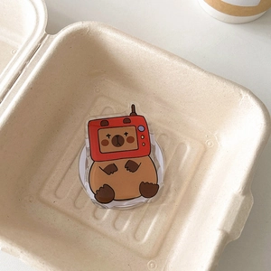 Detail of acrylic phone grip featuring a cartoon bear in a red retro TV head design