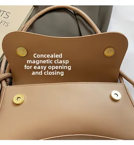 Detail of khaki leather baguette bag with dual gold magnetic buckle closures