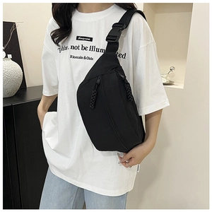 Detail of adjustable wide shoulder strap and buckle on black canvas crossbody bag