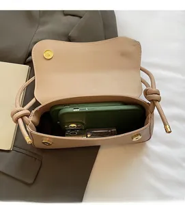 Interior view of beige baguette bag showing space for a phone and lipstick