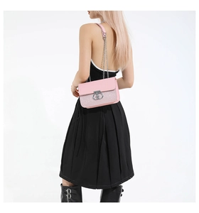 Pink shoulder bag detail showing silver metal buckle and sequin texture on white background