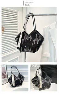 Detail of black quilted tote bag featuring colorful wave patterns and a fashion label