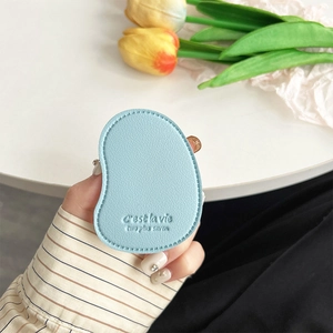 Close-up of light blue pebble leather phone holder with embossed C'est la vie text