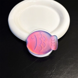 Close-up of a laser colorful fish-shaped magnetic phone grip with pink-blue gradient