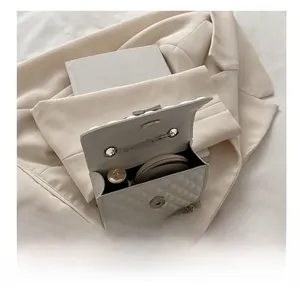 Interior view of white quilted chain bag showing capacity for lipstick and cushion