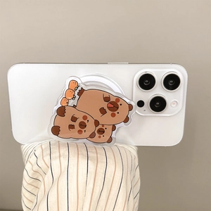 Close-up of cute acrylic capybara phone grip on a white smartphone held by a hand