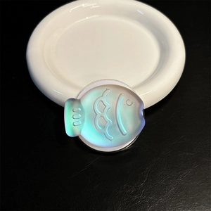 Macro shot of fish-shaped magnetic phone grip with colorful iridescent gradient finish
