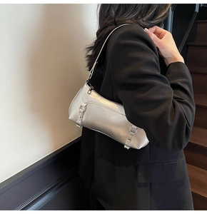 Silver metallic baguette shoulder bag styled with a minimalist black blazer in high contrast