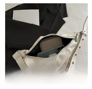 Interior view of cream crescent bag showing capacity for wallet and smartphone