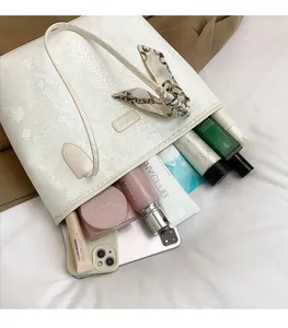 Top view of white snakeskin tote bag showing spacious interior for essentials